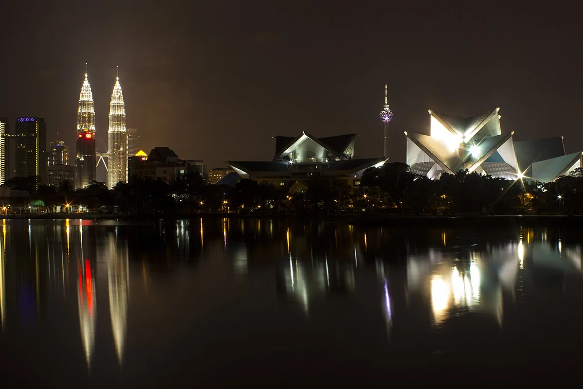 Kuala Lumpur skyline across a lake at night